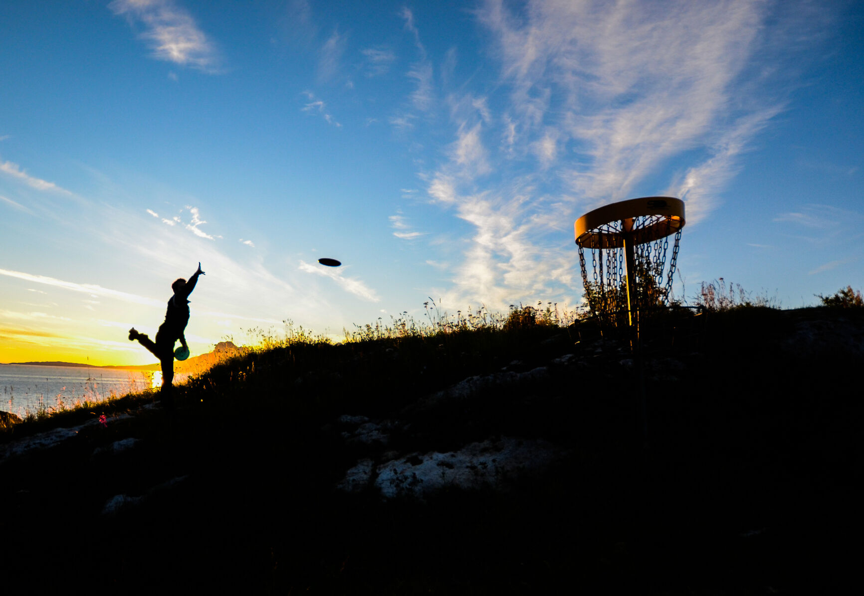Disc golf in sunset in Bratten activity park, Bodø, Norway. Dreamstime